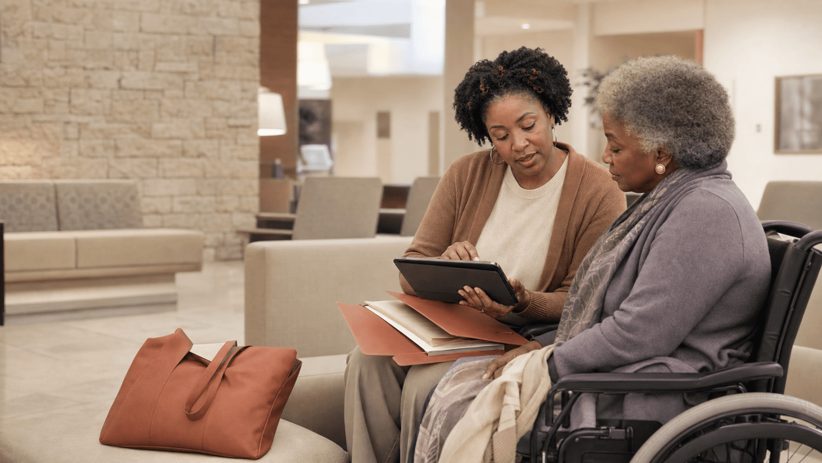 A Black caregiver in a medical lobby